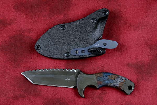 "Krag" tactical, counterterrorism, crossver knife, obverse side view in ATS-34 high molybdenum martensitic stainless steel blade, 304 stainless steel bolsters, multicolored tortoiseshell  G10 fiberglass/epoxy composite handle, hybrid tension tab-locking sheath in kydex, anodized aluminum, black oxide stainless steel and anodized titanium