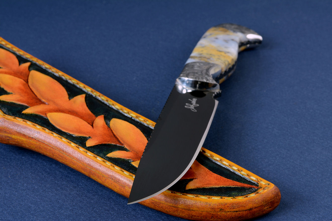 "Aquila" obverse side view in mirror polished and hot blued O1 high carbon tungsten-vandium tool steel blade, hand-engraved 304 stainless steel bolsters, Golden Plume Agate gemstone handle, hand-carved, hand-dyed leather sheath