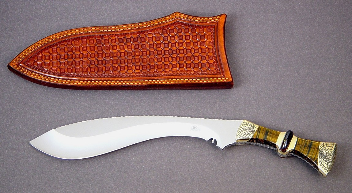 "Nasmyth" fine khukri, obverse side view: 440C high chromium stainless steel blade, hand-engraved brass bolsters, bicolored tiger eye quartz, Australian tiger iron gemstone handle, hand-stamped leather sheath