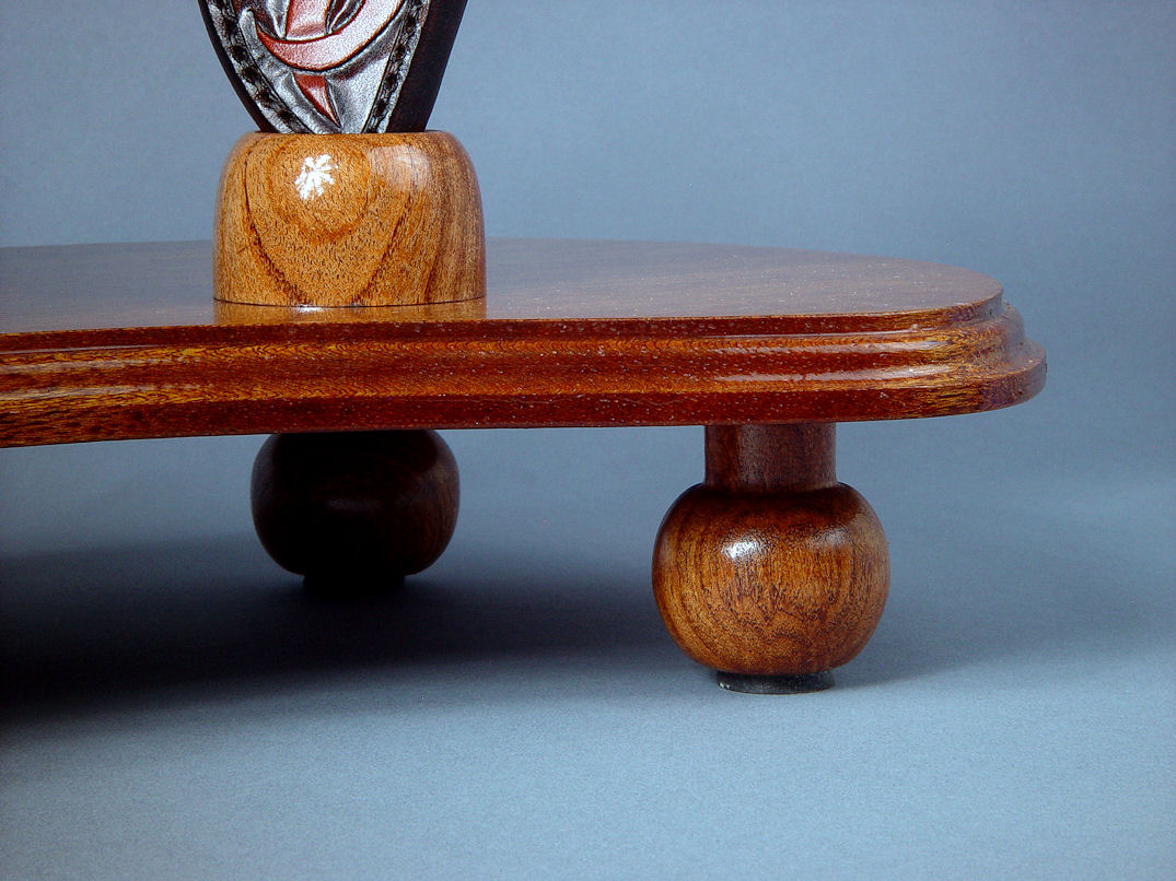 "Tribal" sculptural knife display stand, base and foot detail. Base is solid lauan hardwood, feet are hand-turned mesquite with neoprene inlays for non-scratch surface contact