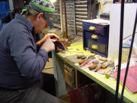 Fileworking a large master chef's knife on the bench. Note various files and tools used in the process