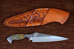 "Malaka" fine custom handmade knife, reverse side view  in hand-engraved CPM 154CM powder metal technology stainless steel, T4 deep cryogenically treated, bolsters of hand-engraved 304 stainless steel, Plasma agate and Nephrite Jade gemstone handle, hand-carved leather crossdraw sheath with stainless steel hardware